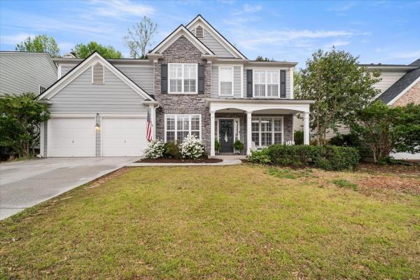 a front view of a house with a yard