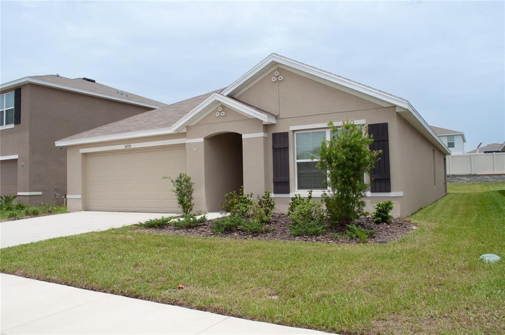 a front view of house with garden