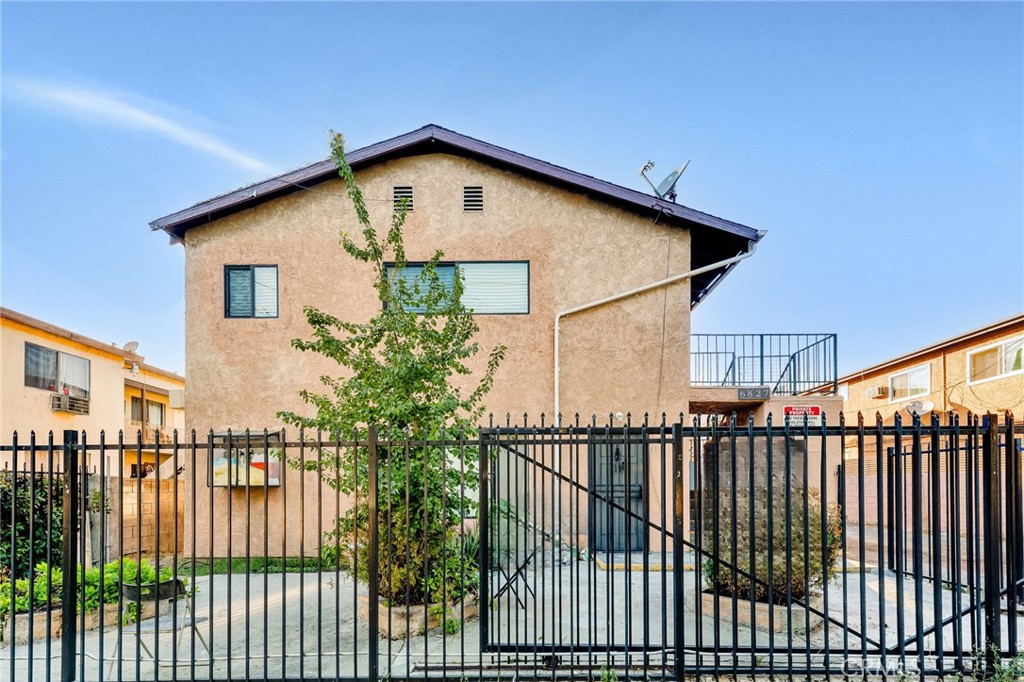 a view of a house with wooden fence and floor