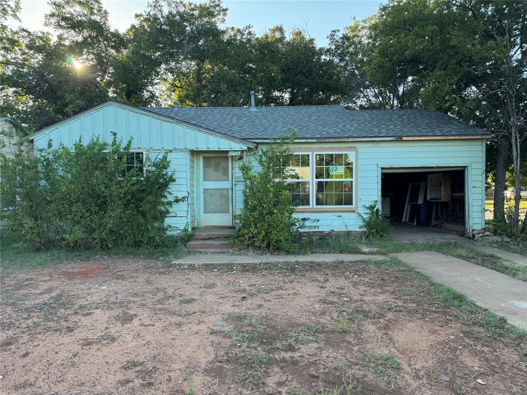 front view of a house with a yard and a garage