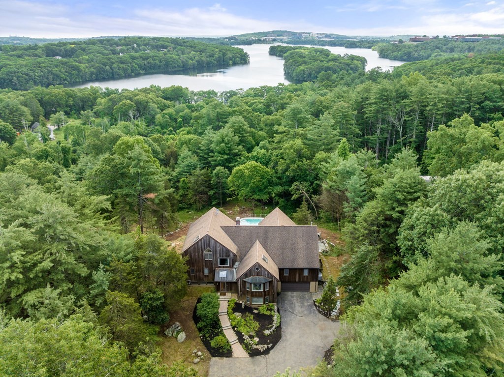 an aerial view of a house with yard and outdoor seating