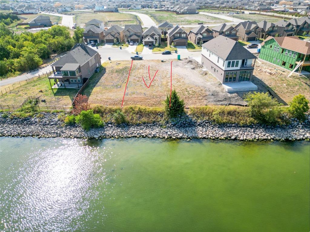 an aerial view of residential houses with outdoor space and swimming pool