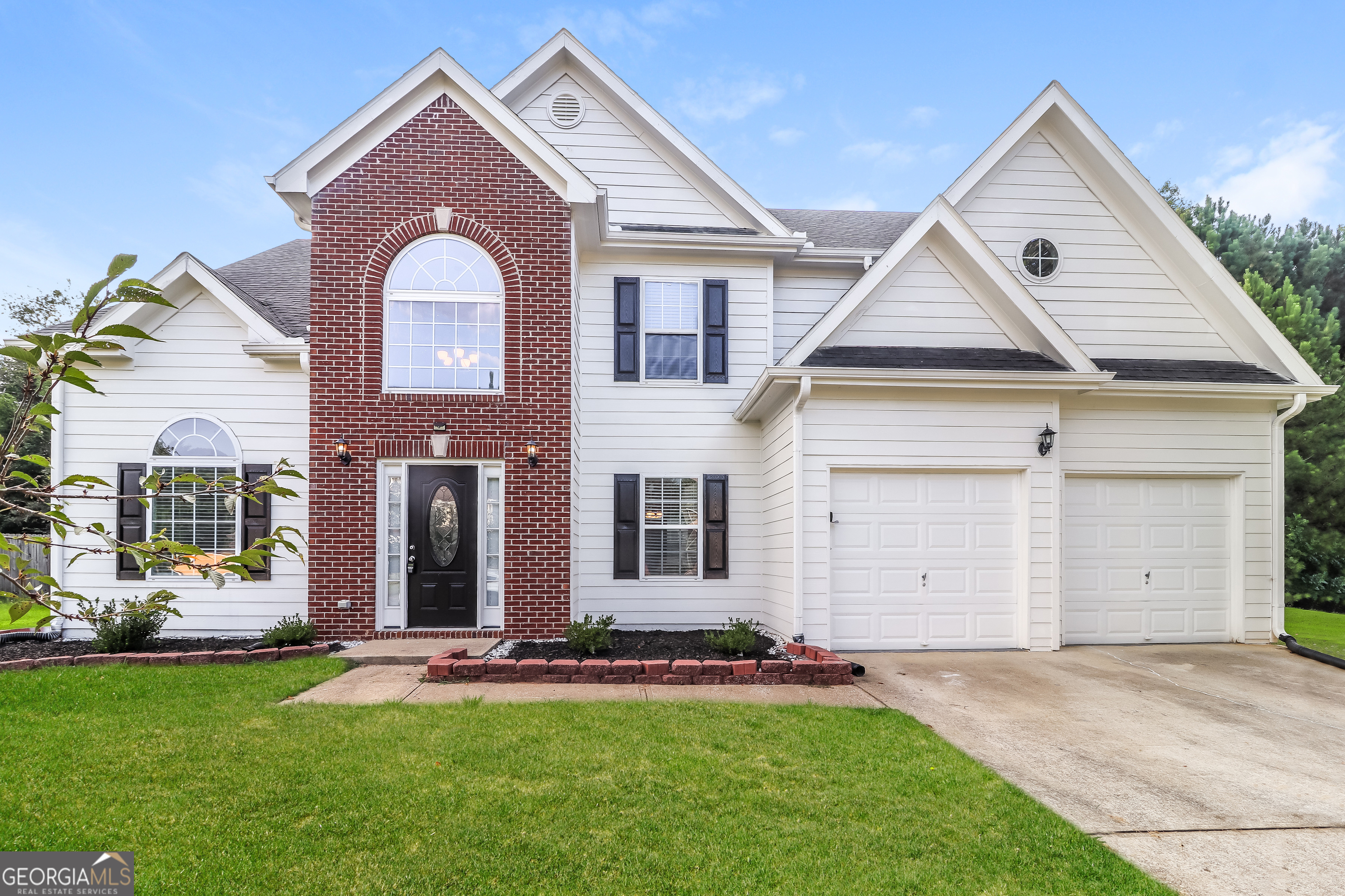 front view of a house with a yard