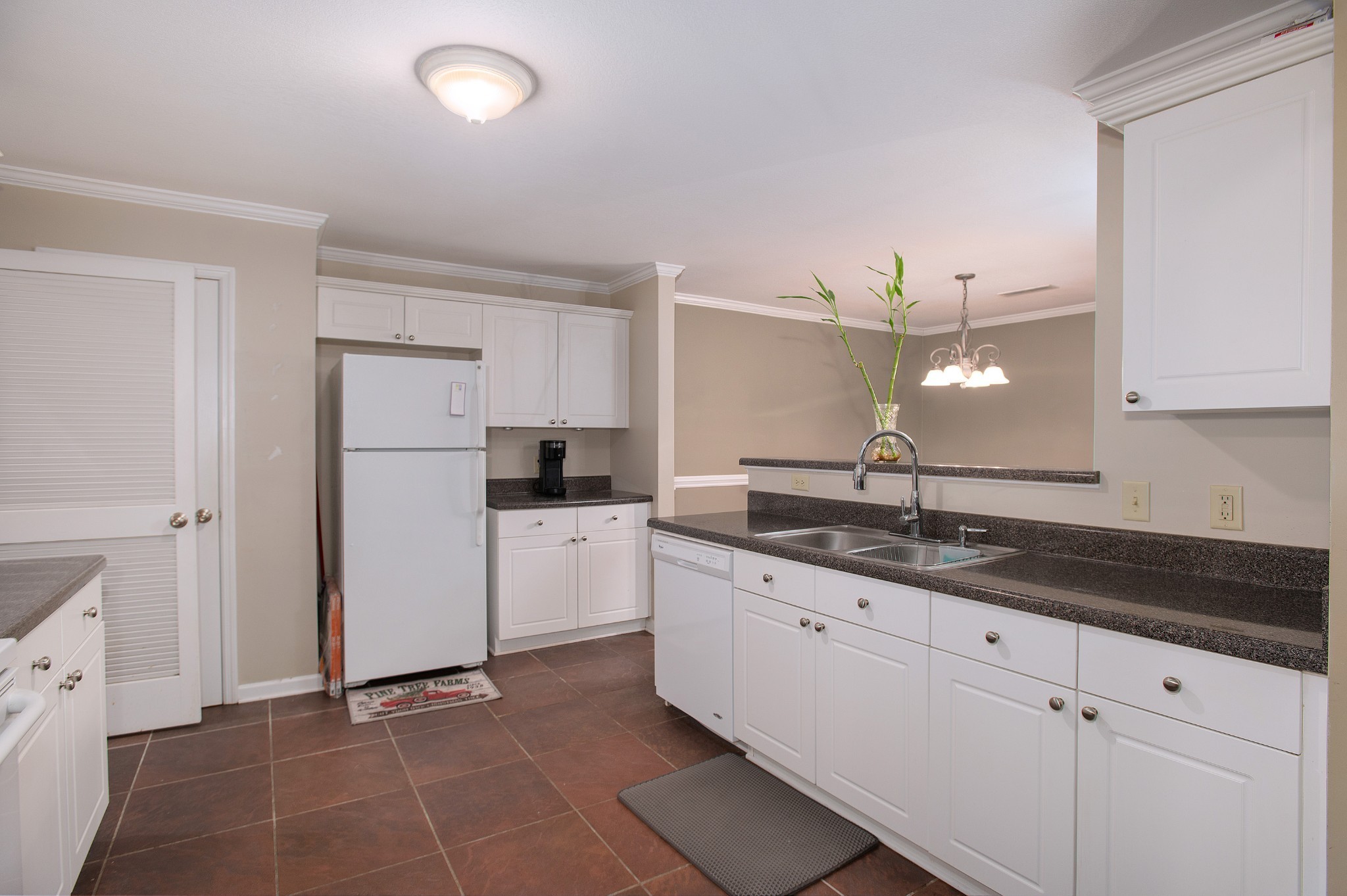 a kitchen with a sink and refrigerator