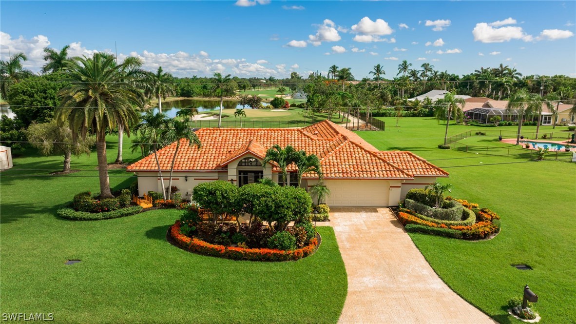 a view of a house with a yard and potted plants