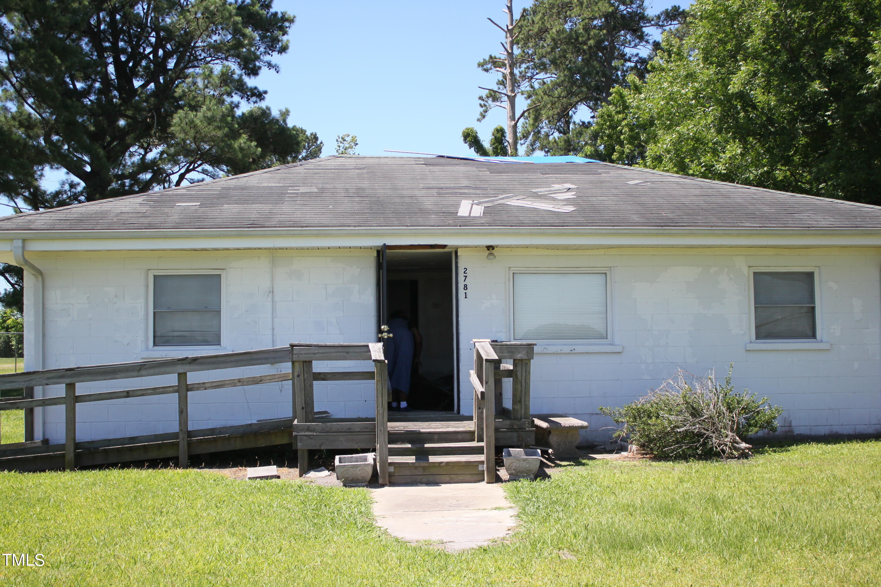 a view of a house with yard and sitting area