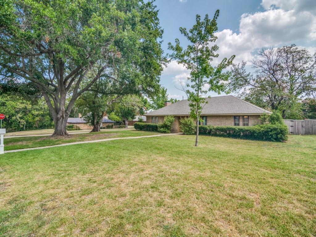 a view of a tree in front of a house