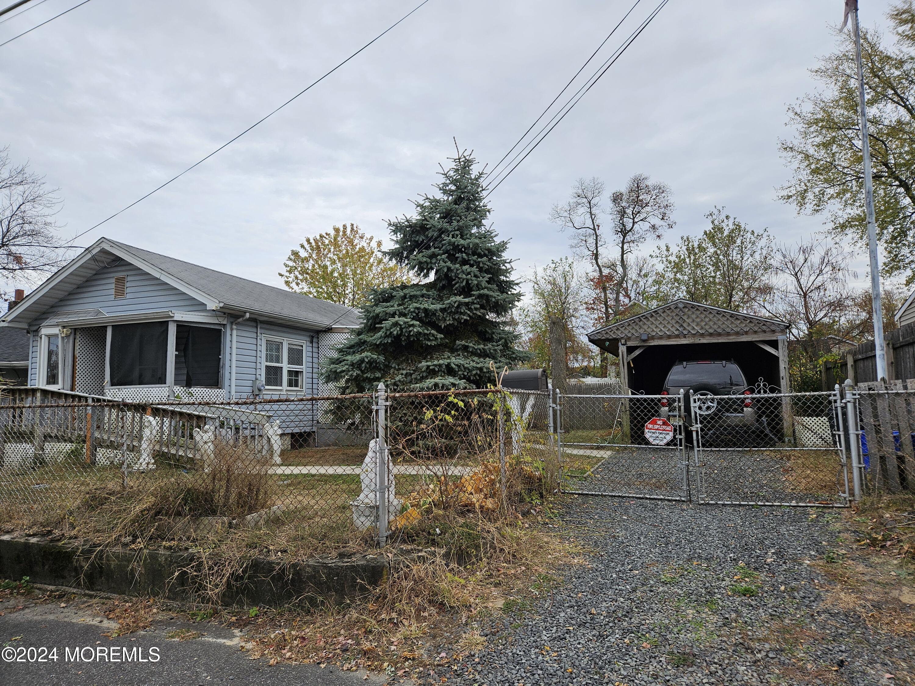 a view of a house with a yard and sitting area