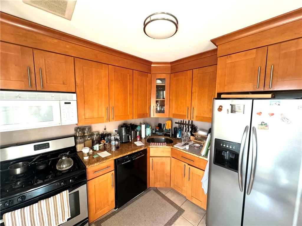 a kitchen with stainless steel appliances a stove refrigerator sink and cabinets