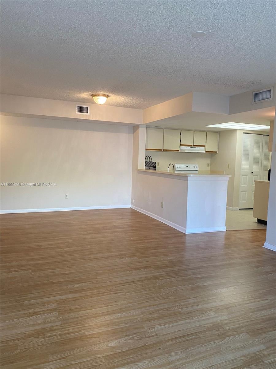 a view of kitchen and wooden floor