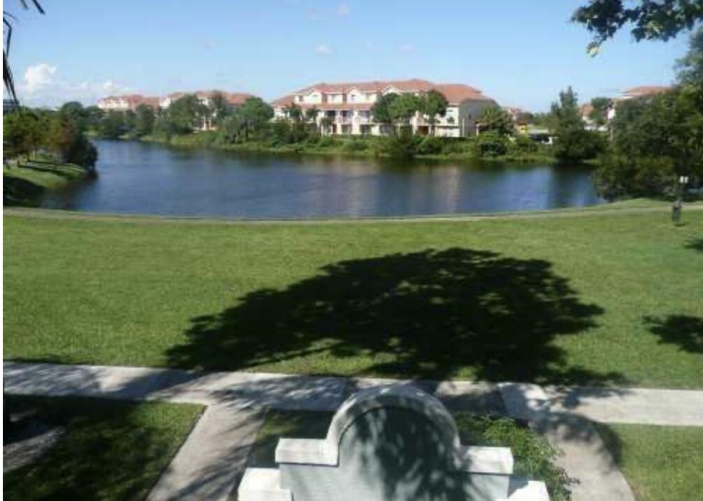 an aerial view of a house with a yard and lake view