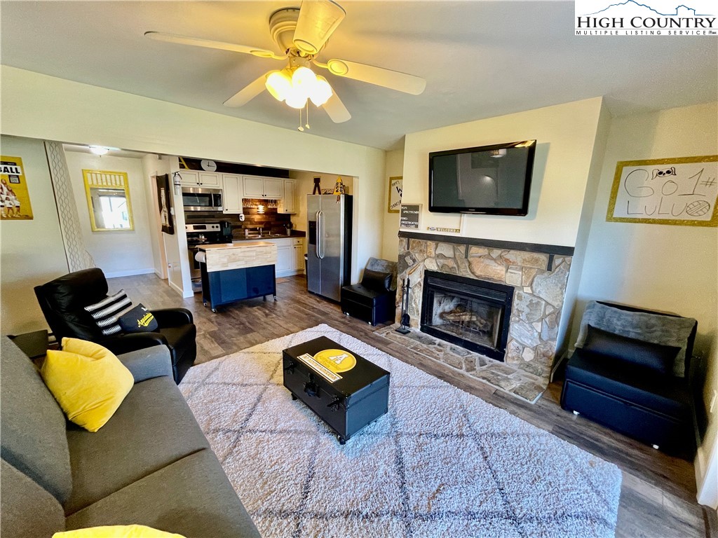 a living room with furniture fireplace and flat screen tv