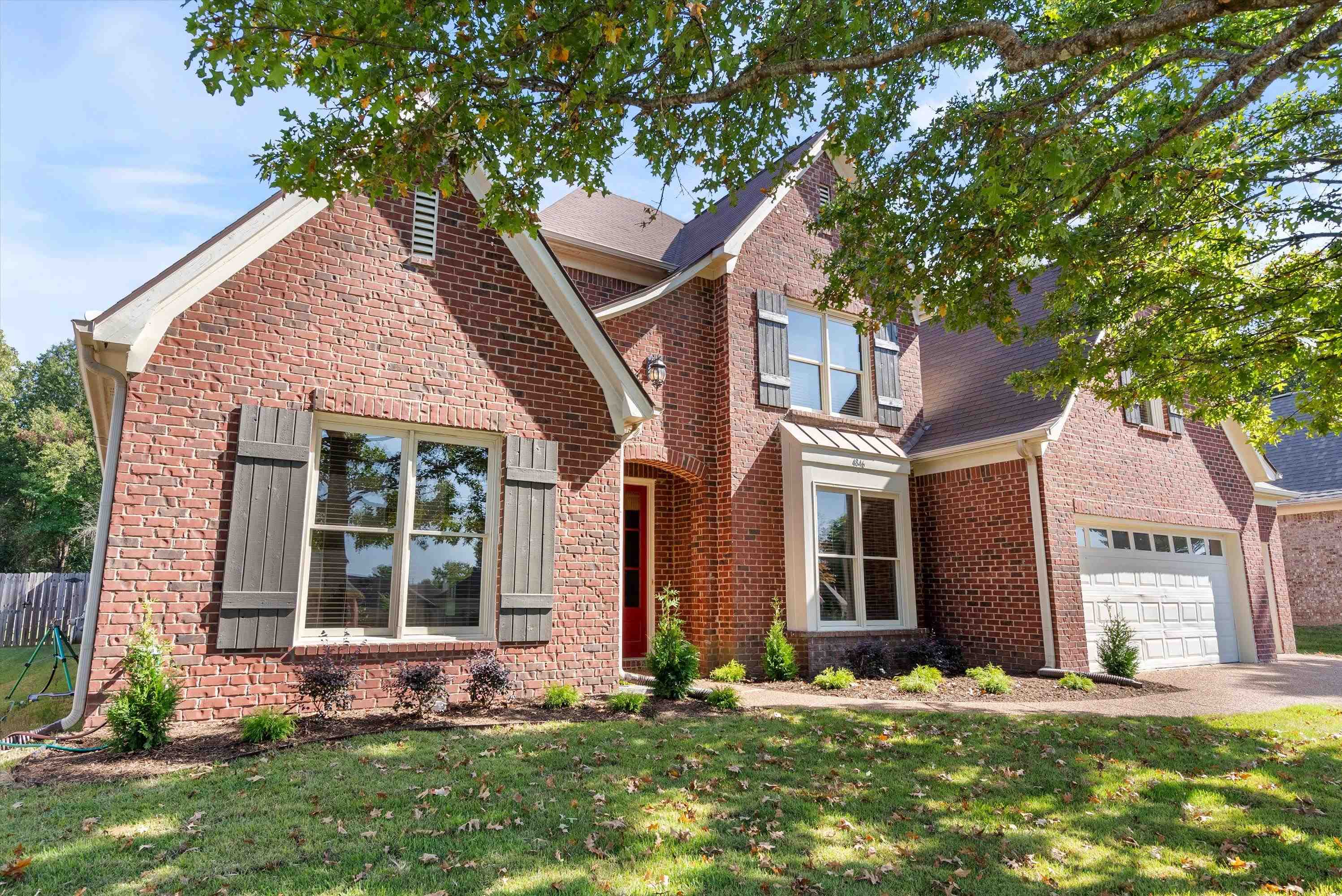 front view of a house with a yard