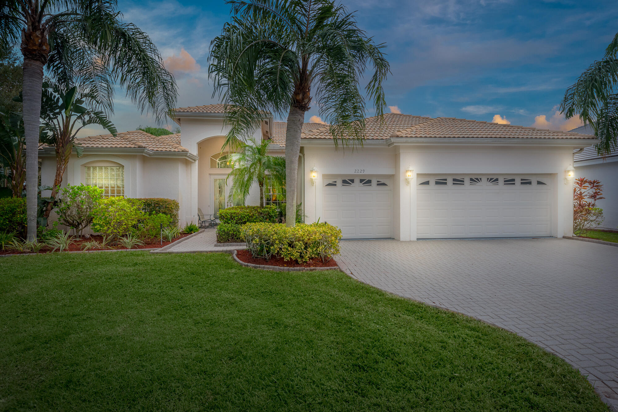 a view of a house with a yard and a garage