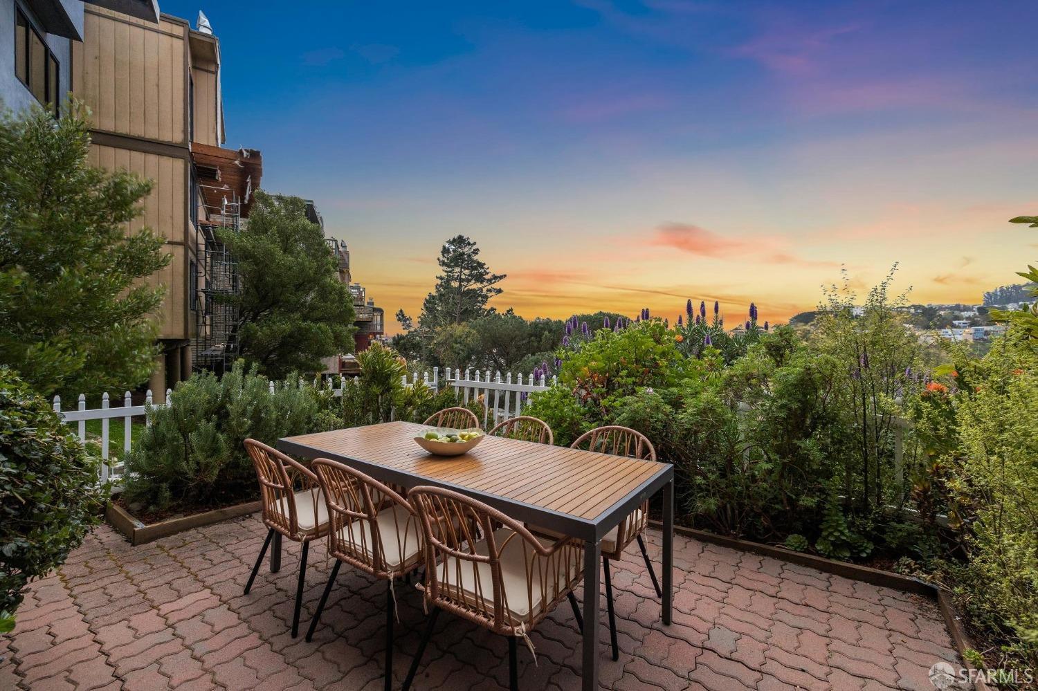 a view of a dinning table and chairs on the roof deck