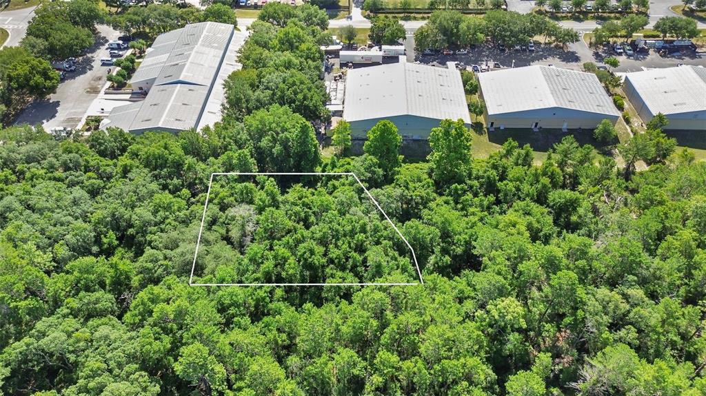 an aerial view of a house with a yard and lake view