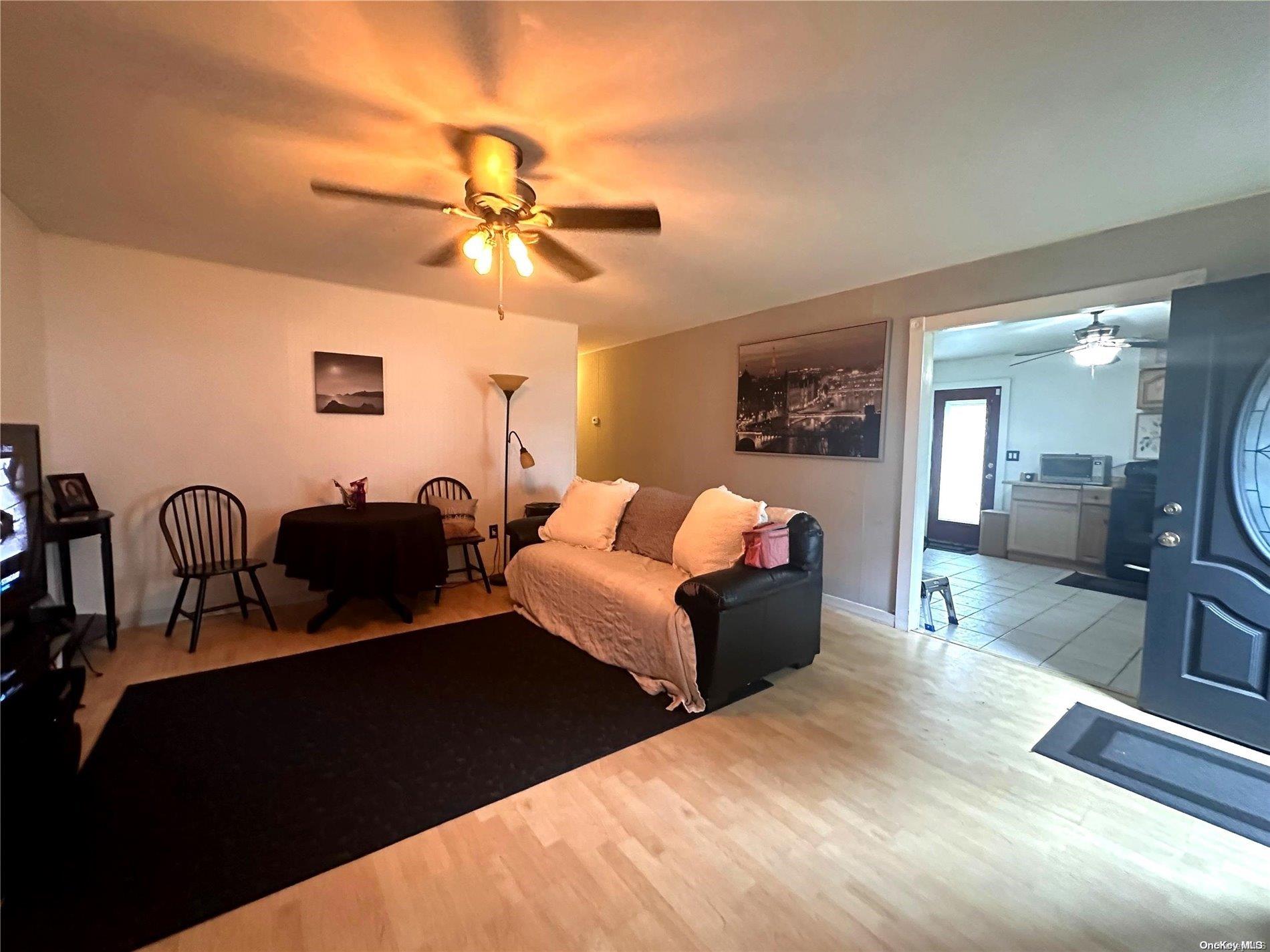 a living room with furniture potted plant and a chandelier