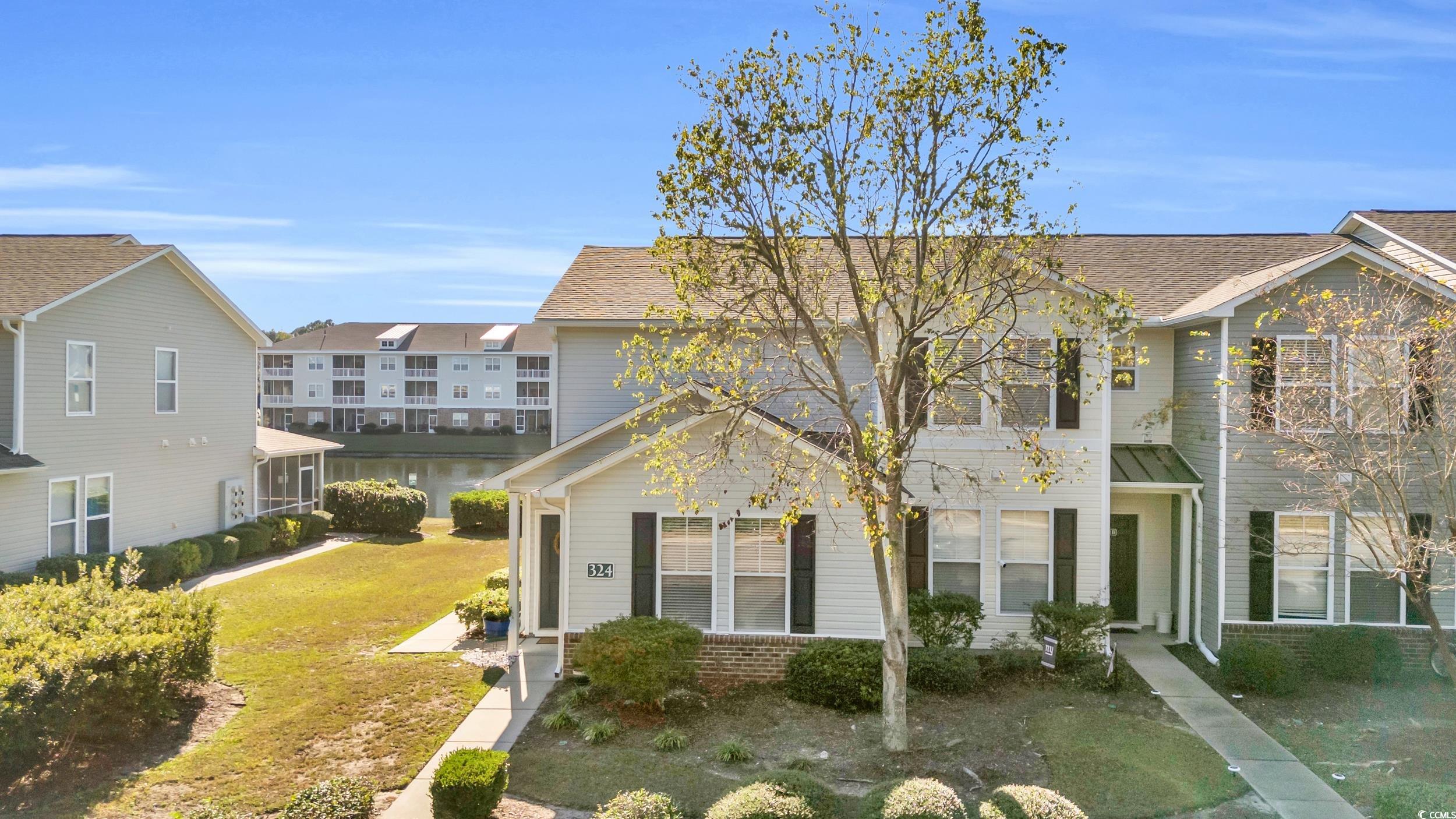 View of property with a front lawn