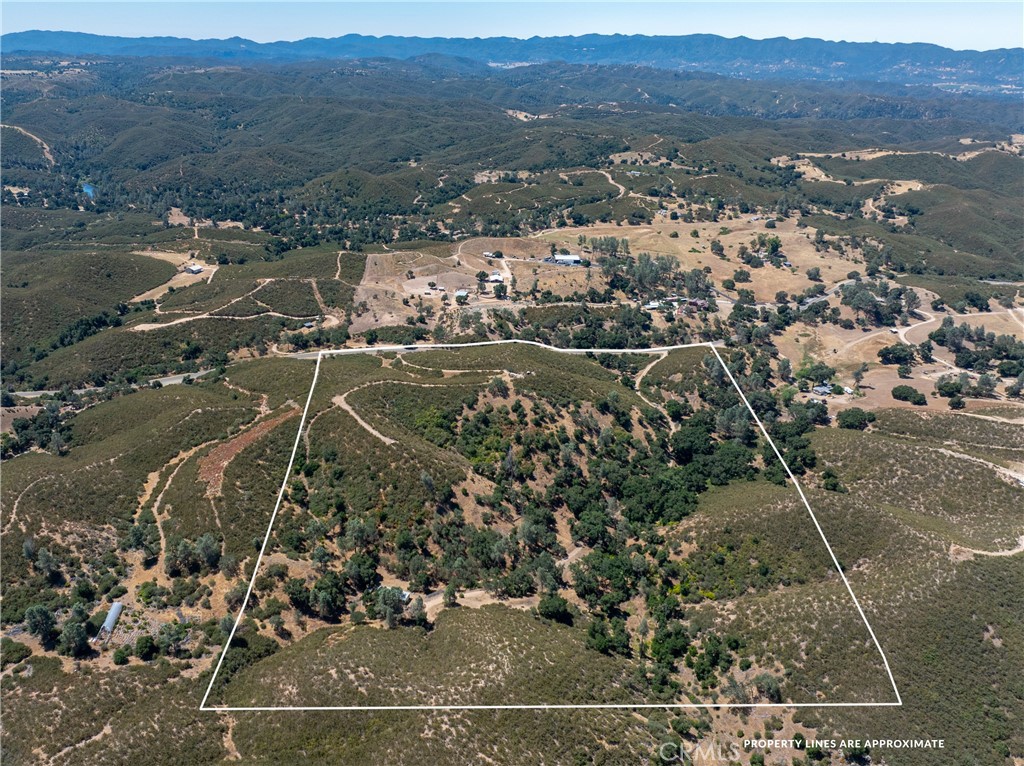 an aerial view of a houses with a yard