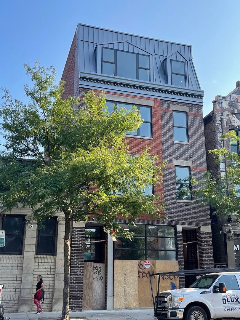 a view of a building with a tree