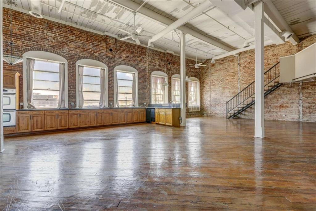 a view of a living room with hardwood floor and staircase