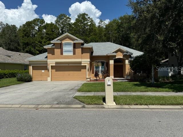 a front view of a house with a yard and garage