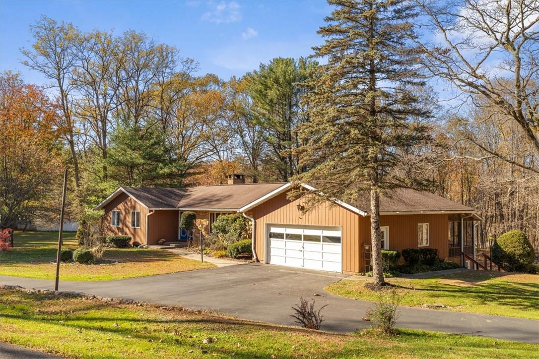 a view of a house with swimming pool and a yard