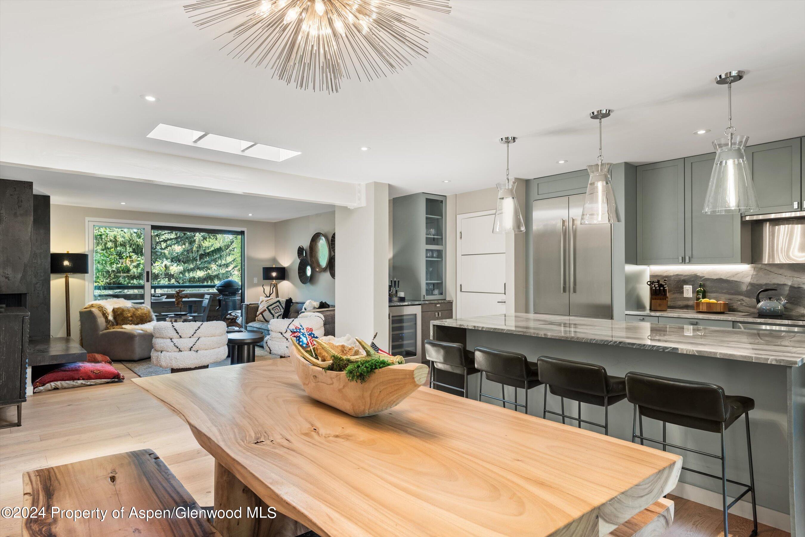 a large kitchen with kitchen island a large counter space a sink appliances and living room view