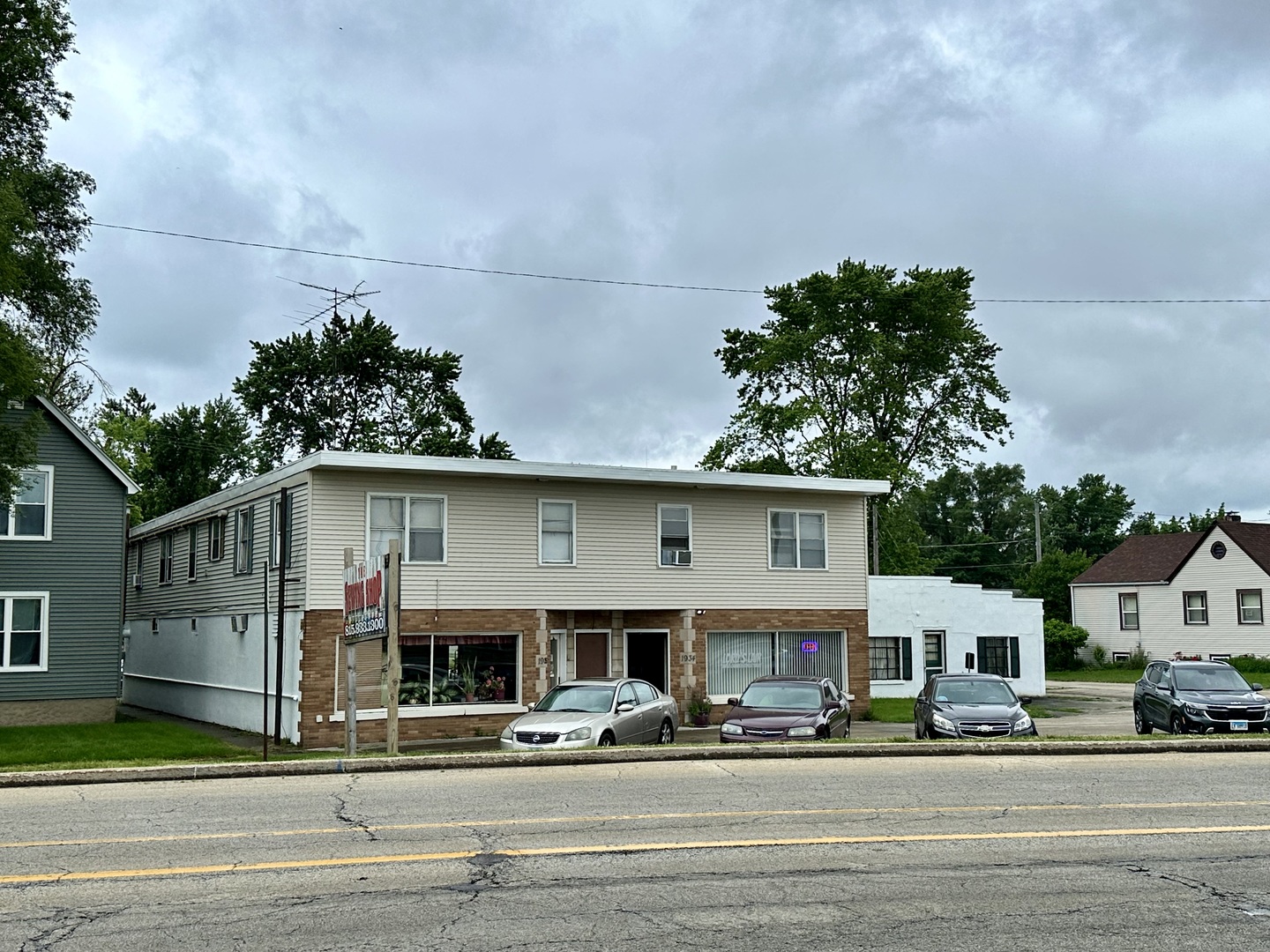 a front view of a house with a road