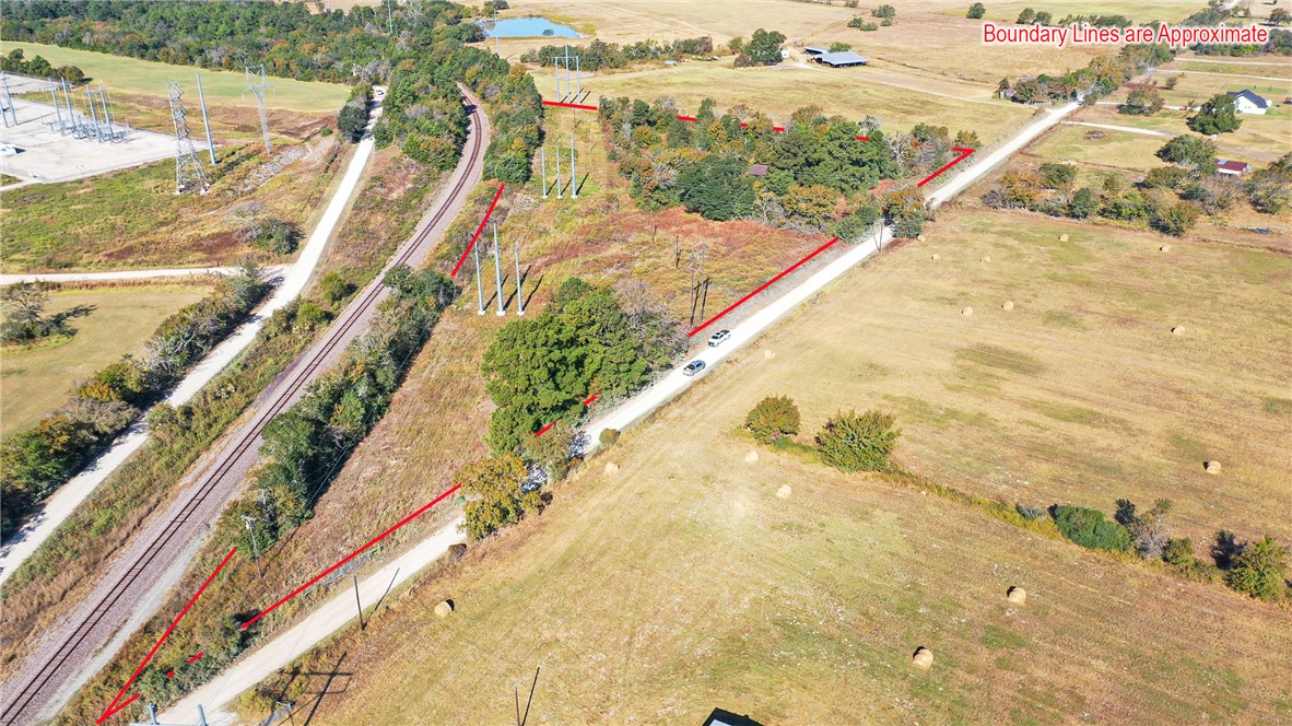 Birds eye view of property featuring a rural view