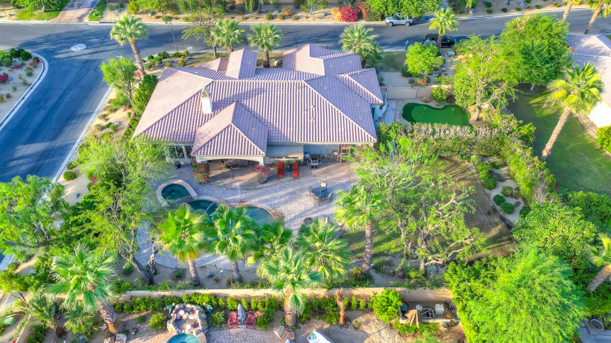 an aerial view of residential house with outdoor space and trees all around