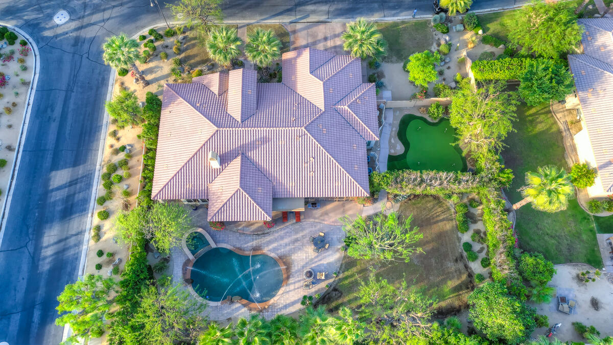 an aerial view of a house with a yard