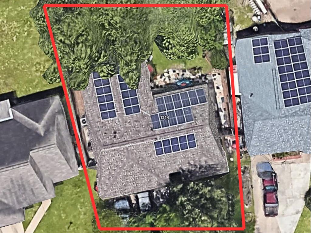 One-story residential property with a sizable rooftop solar panel installation.