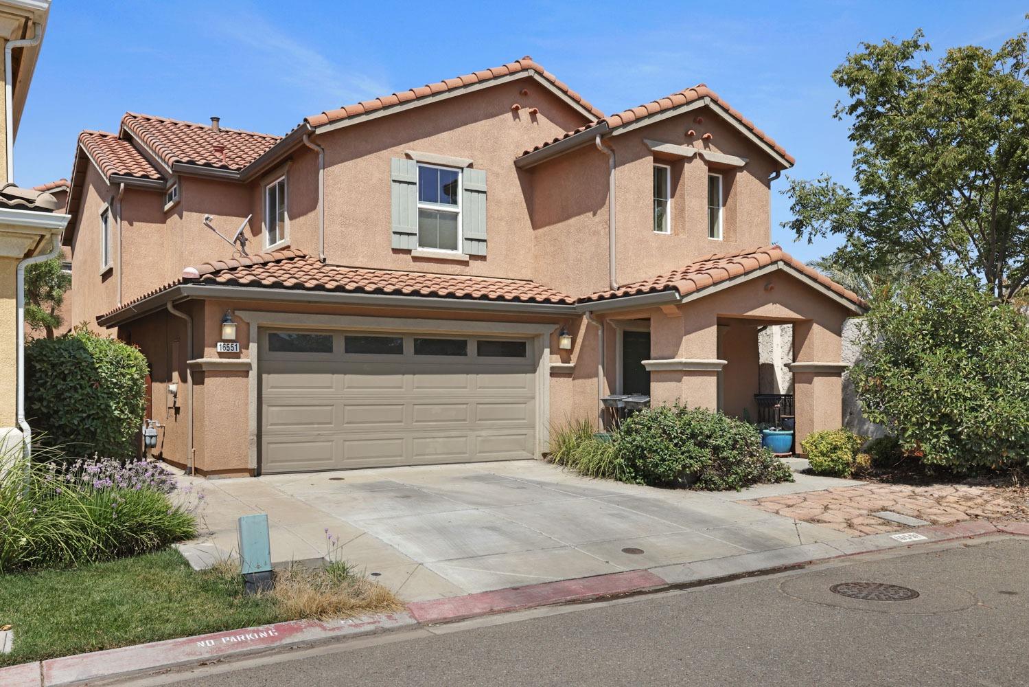 a view of a house with a yard and garage