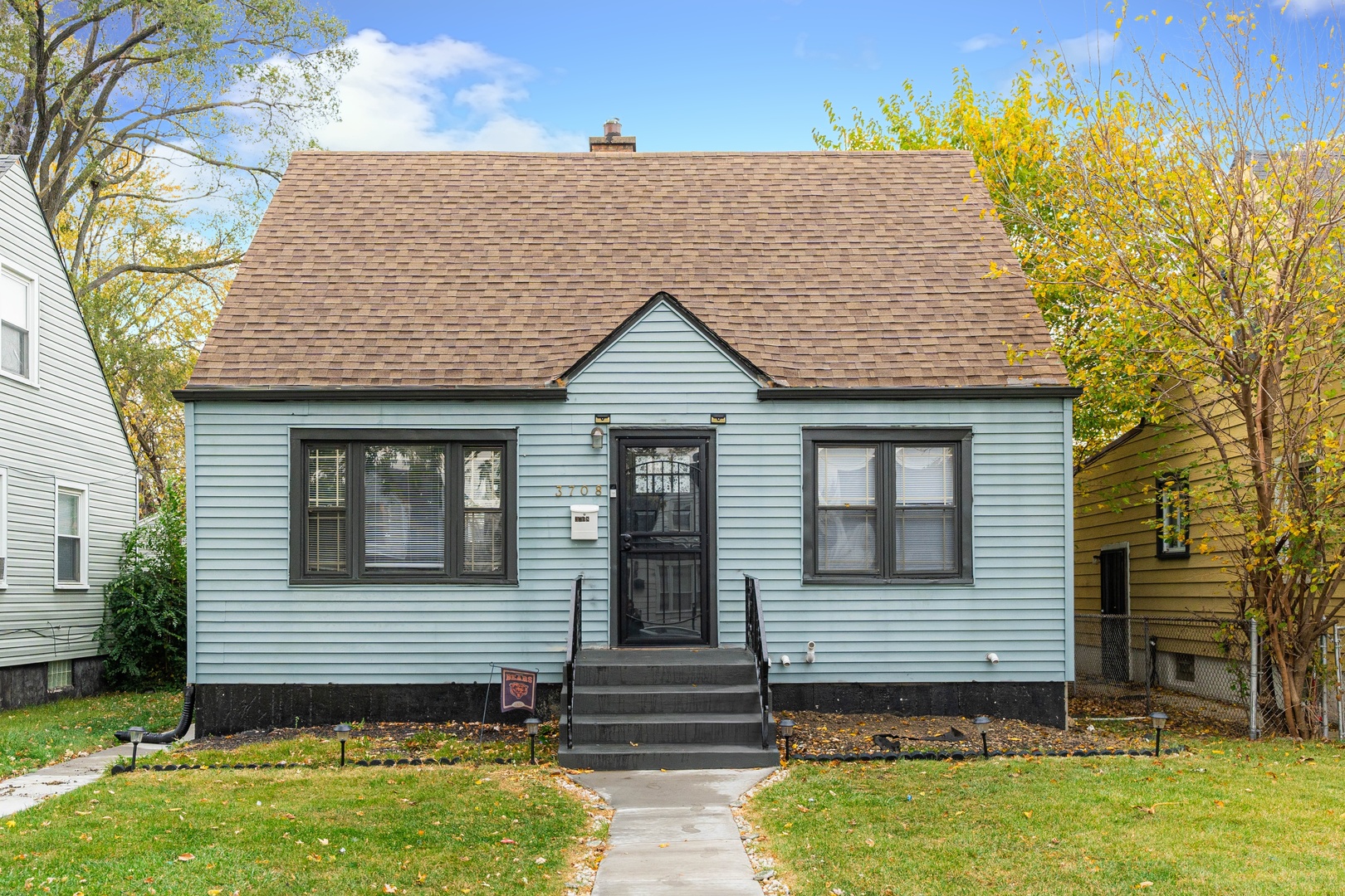 a front view of a house with garden