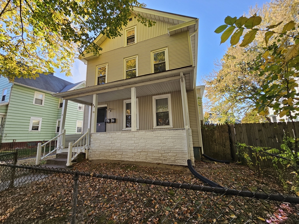 a view of a house with a yard and sitting area