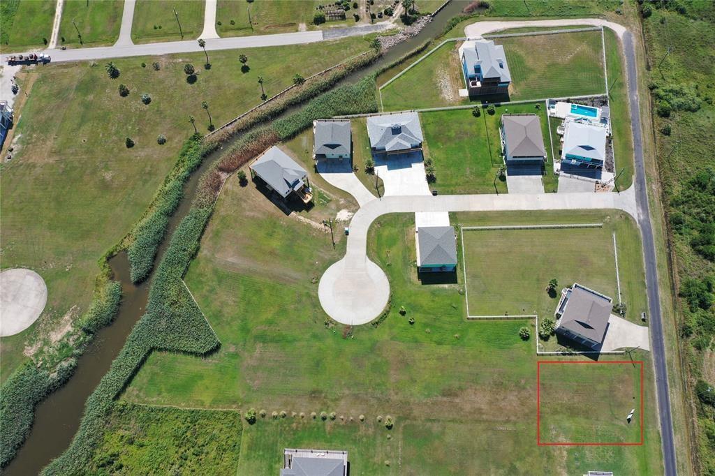 an aerial view of a house with swimming pool and glass windows