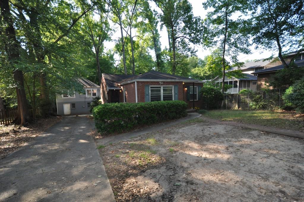 a view of a house with yard and a garden