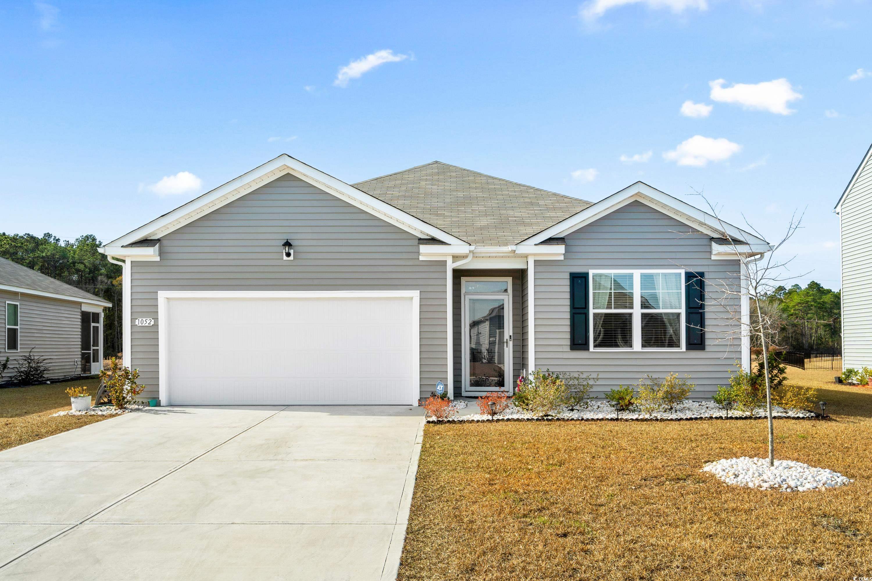 Ranch-style house with a front lawn and a garage