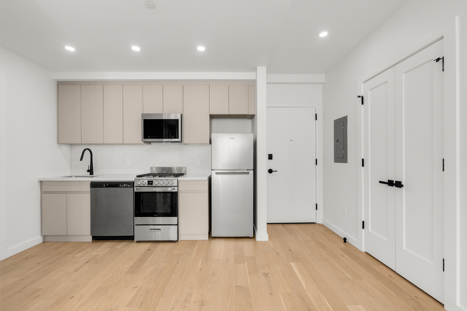 a kitchen with stainless steel appliances granite countertop a refrigerator and a stove top oven