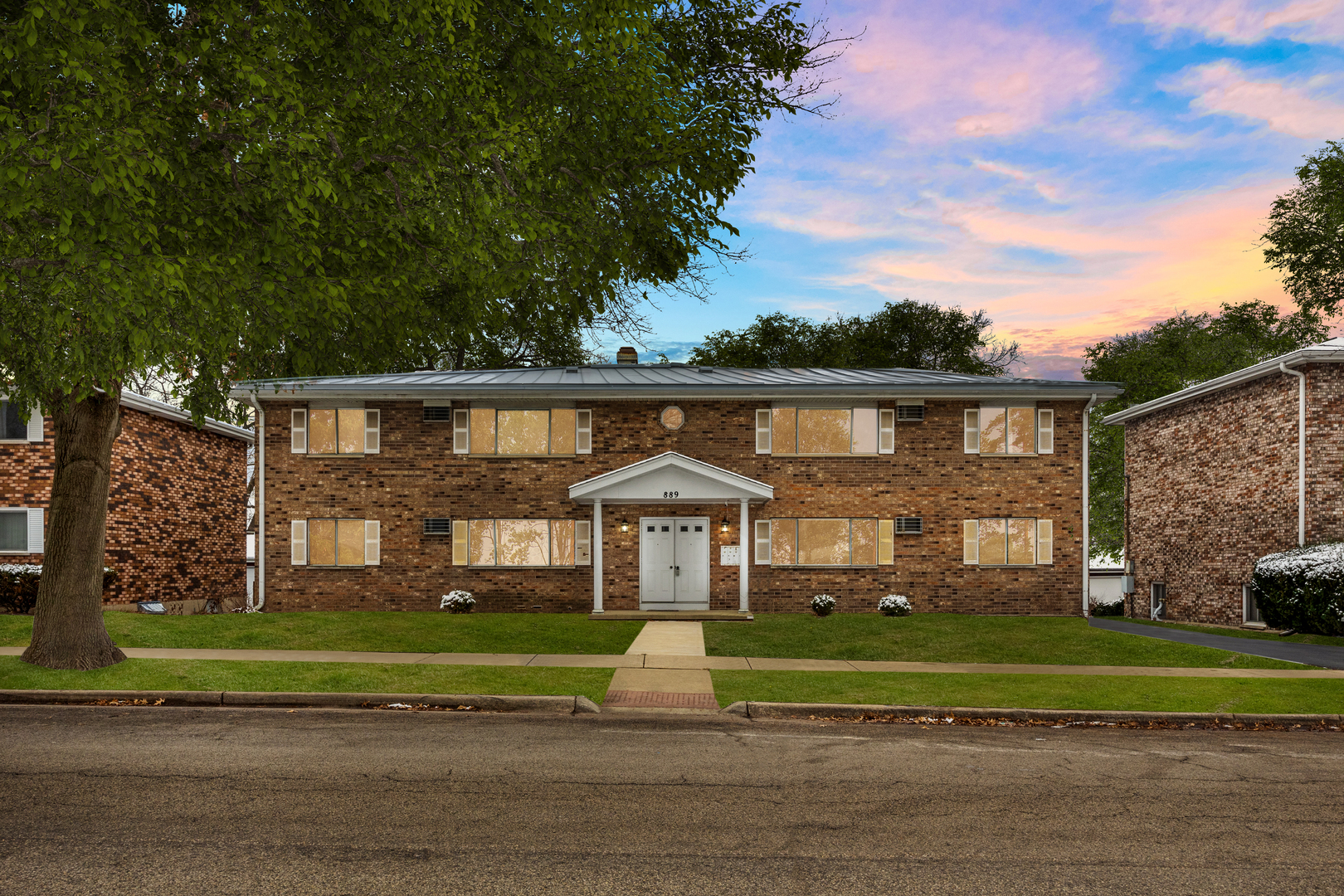 a front view of a house with a yard