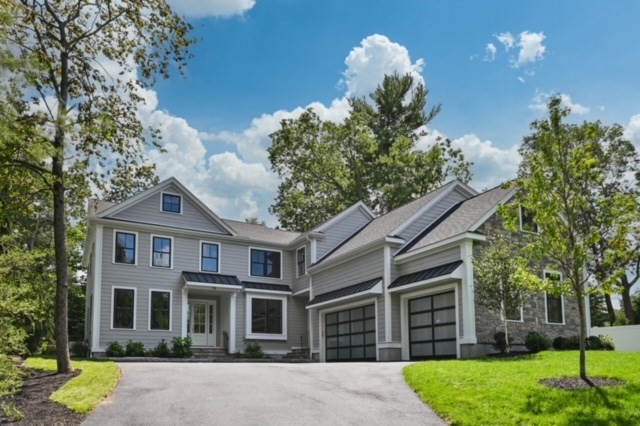 a front view of a house with a yard and outdoor seating