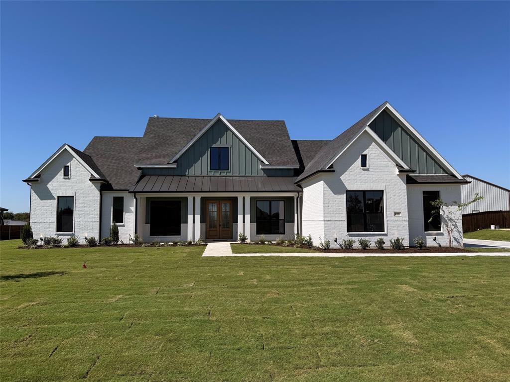 a front view of house with yard and sitting area