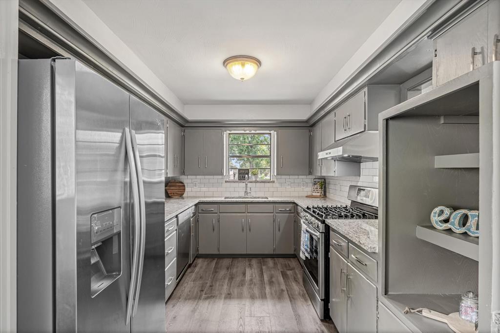 a kitchen with a sink appliances and cabinets