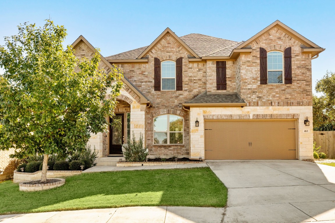 a front view of a house with a yard