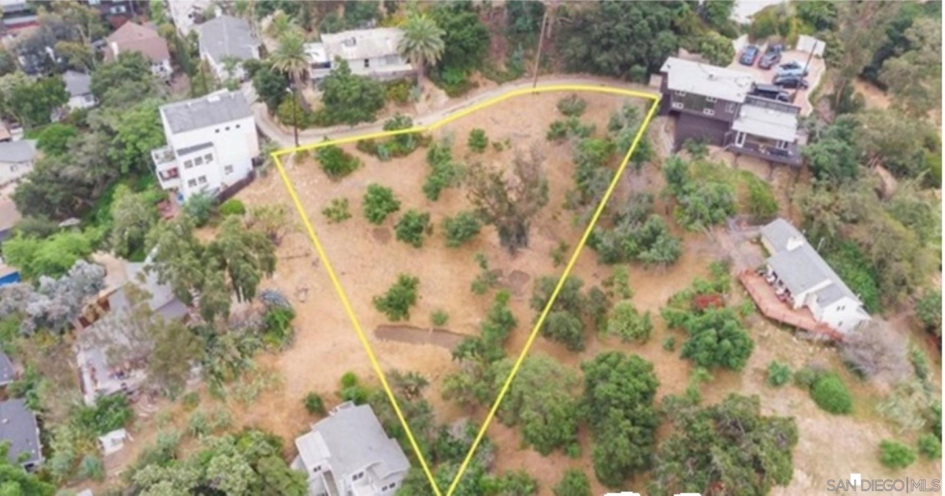 an aerial view of residential house with outdoor space and trees all around