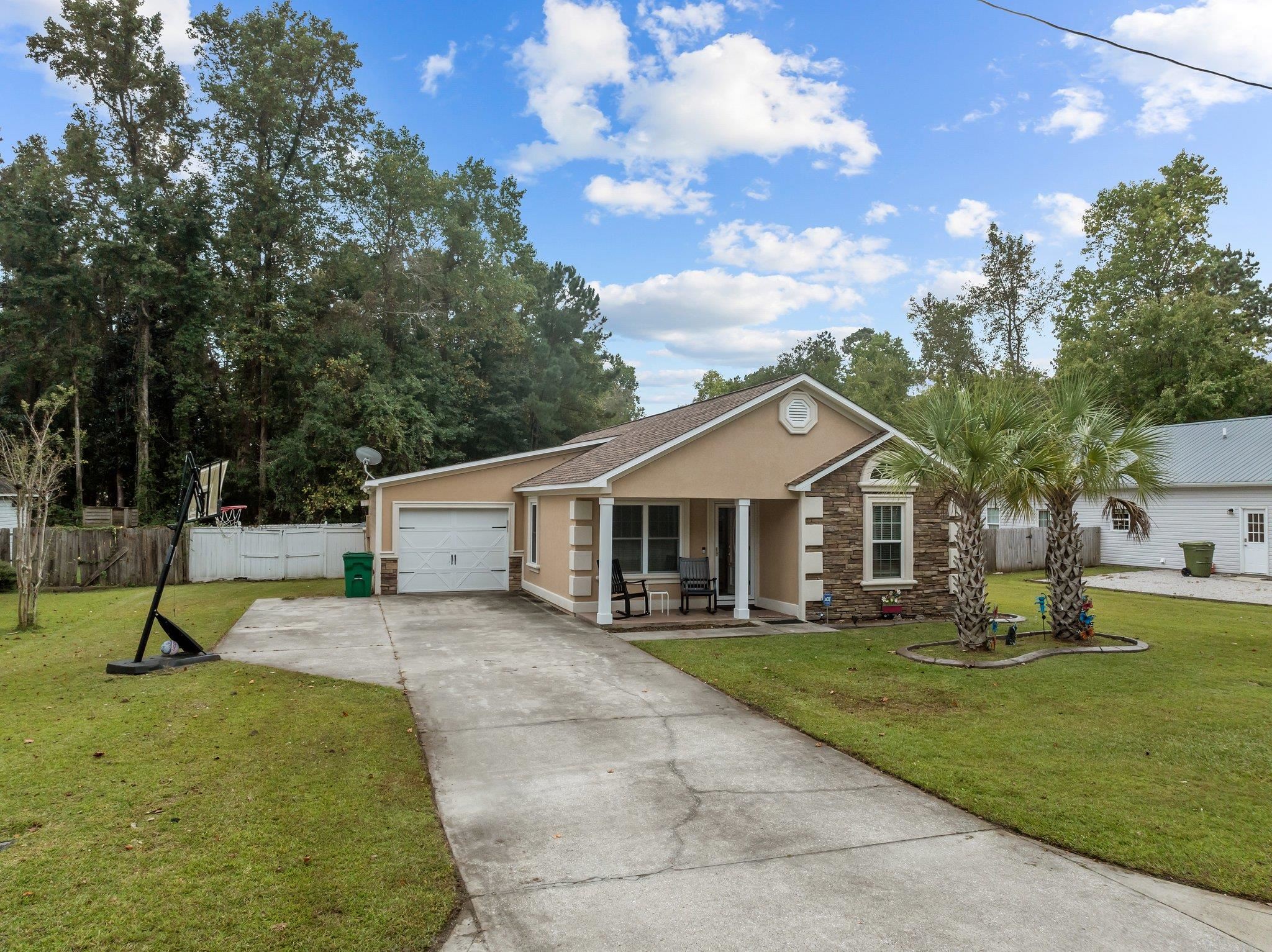 Ranch-style home with a front yard and a garage