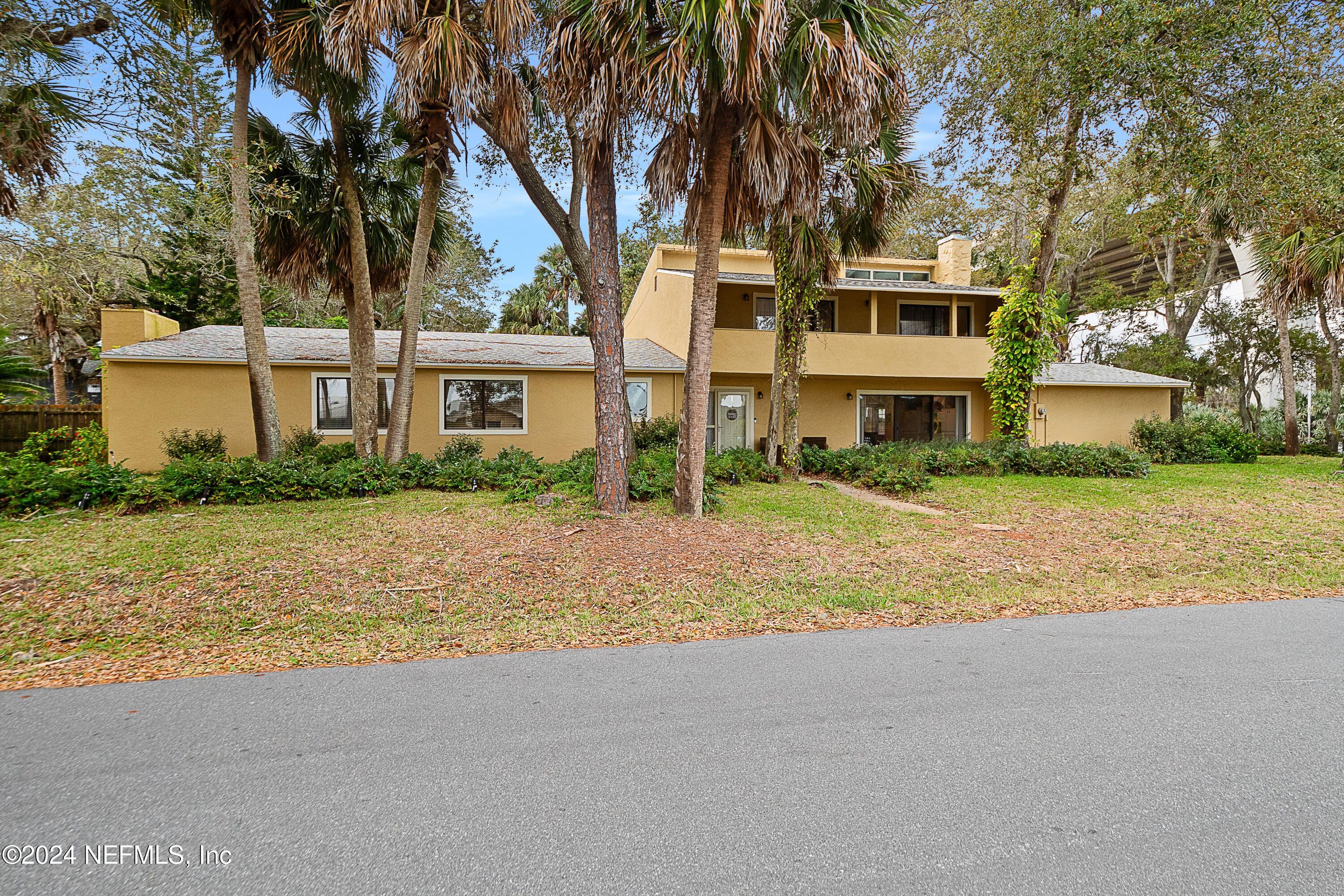 a house with palm tree in front of it