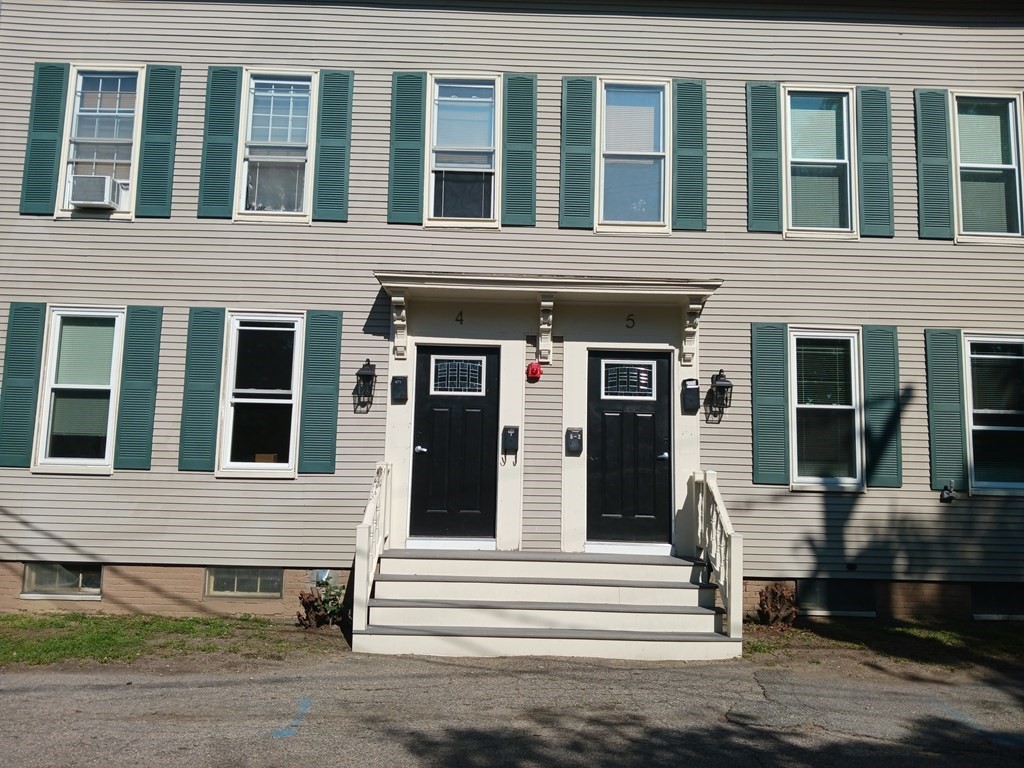 a view of a brick house with a lounge chair