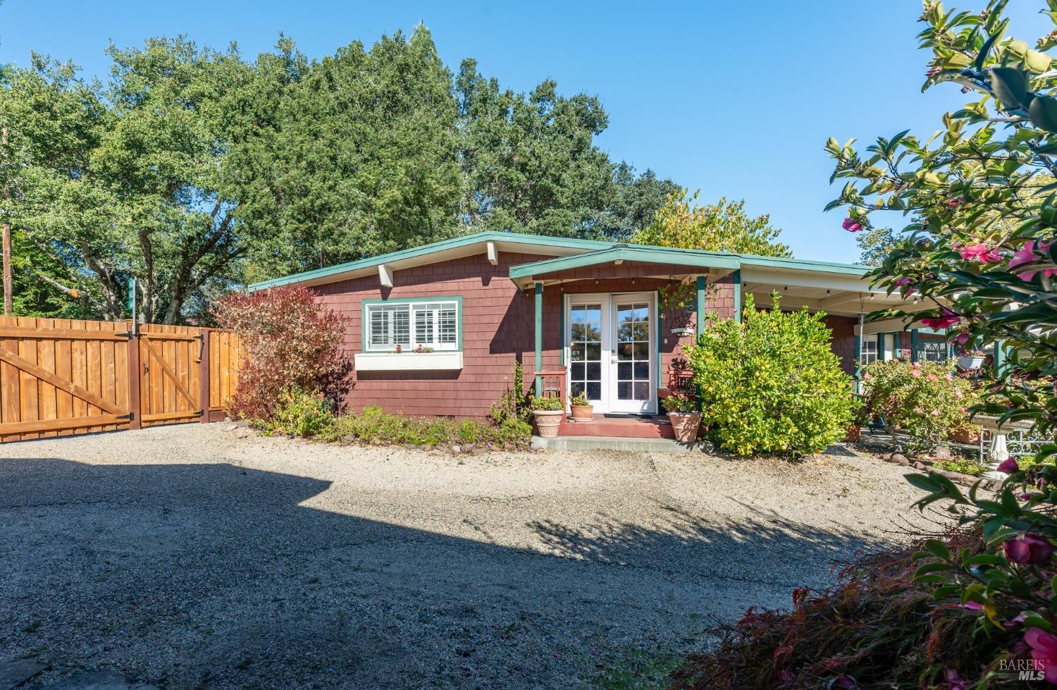 a front view of a house with a yard and a garden